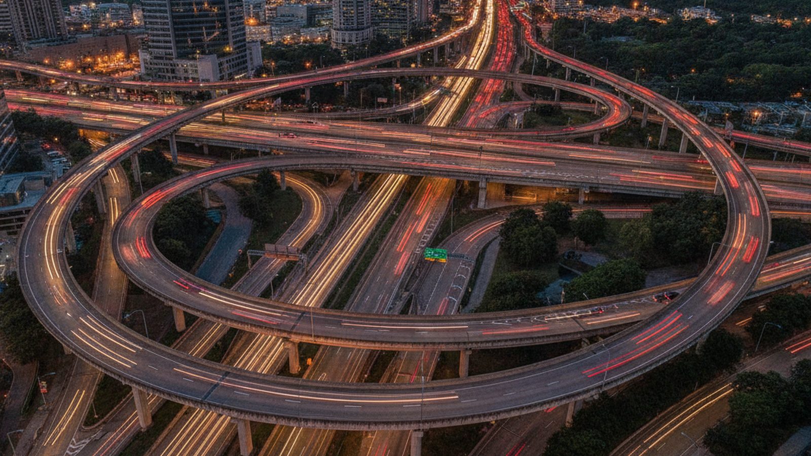 An aerial shot of a busy and complex highway interchange with many cars.